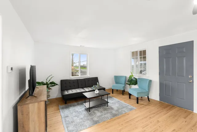 a large white kitchen with a sink and dishwasher