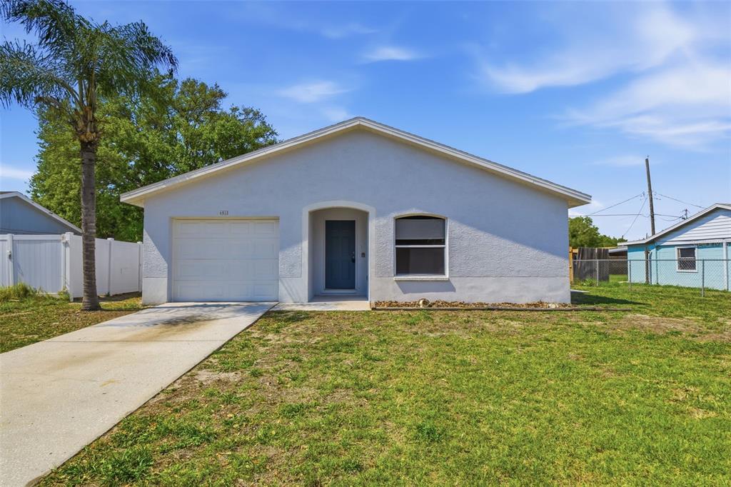 a front view of house with yard and trees