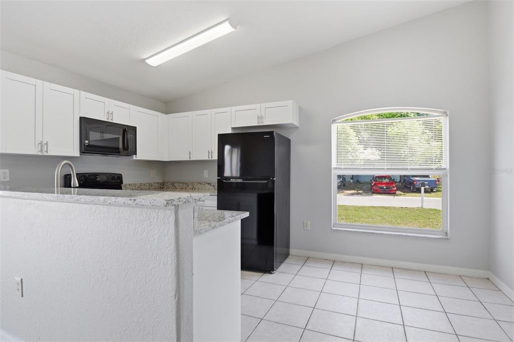 6018 Flora Terrace Apollo Beach, FL 33572 - Photo 13 of 33 a kitchen with stainless steel appliances granite countertop a refrigerator sink and stove