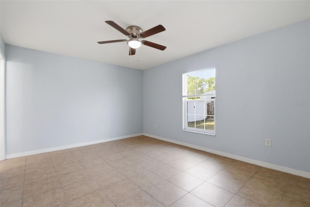 6018 Flora Terrace Apollo Beach, FL 33572 - Photo 21 of 33 an empty room with windows and fan