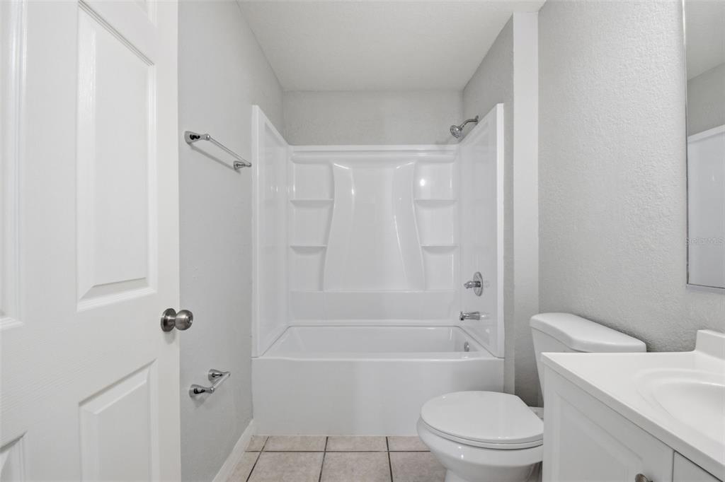 6018 Flora Terrace Apollo Beach, FL 33572 - Photo 26 of 33 a bathroom with a toilet and a bath tub