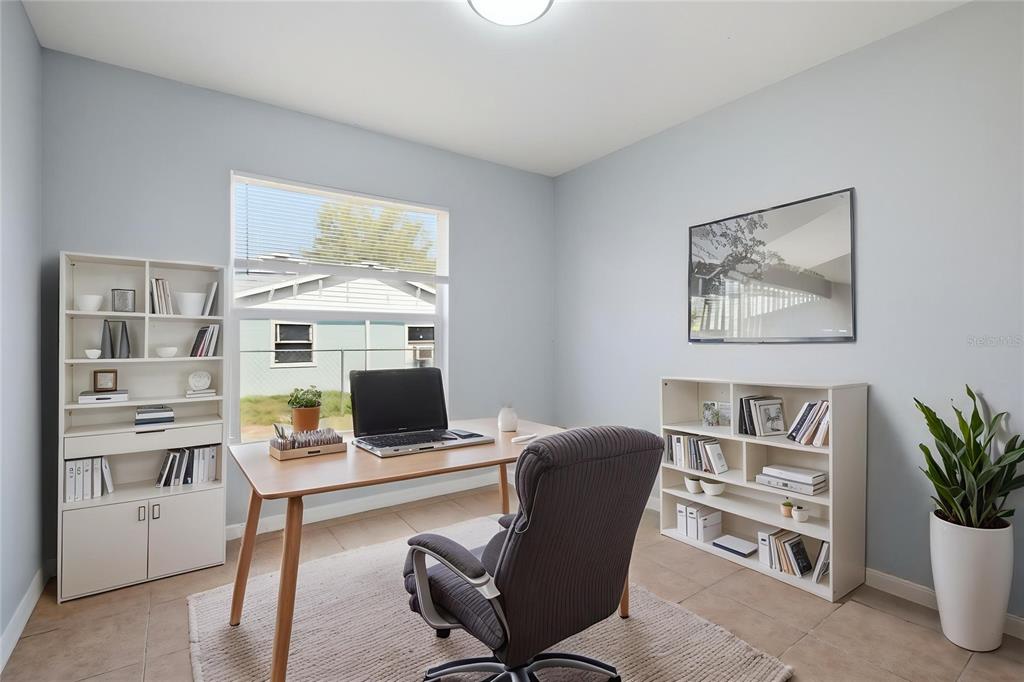 6018 Flora Terrace Apollo Beach, FL 33572 - Photo 5 of 33 a view of a workspace with furniture and a potted plant