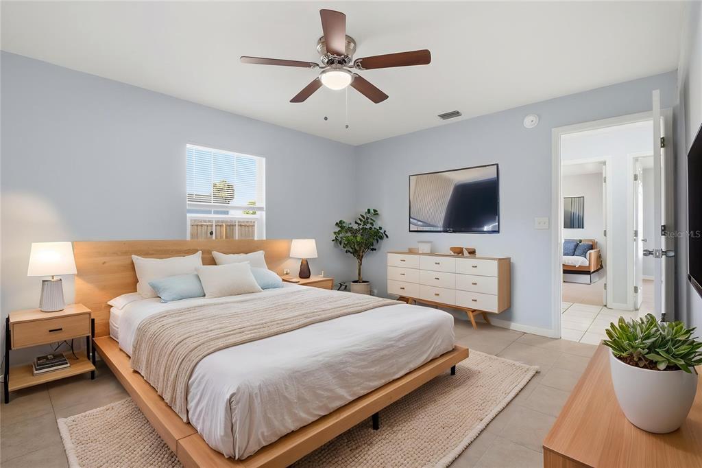 6018 Flora Terrace Apollo Beach, FL 33572 - Photo 7 of 33 a bedroom with a bed and a flat screen tv