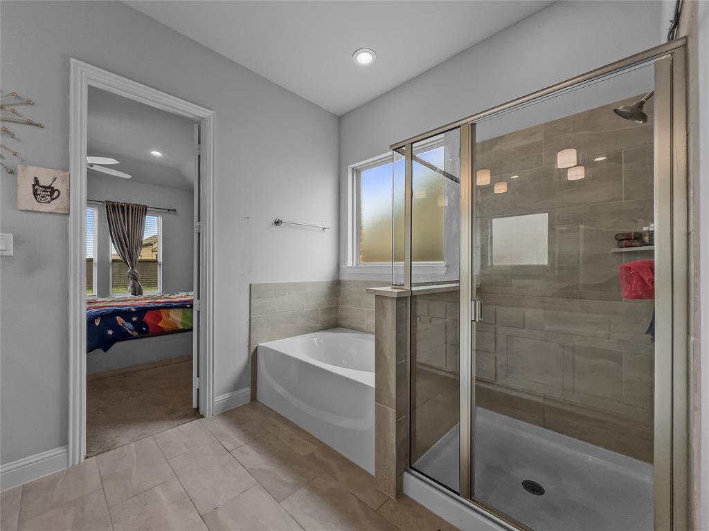 116 Chaco Drive Forney, TX 75126 - Photo 15 of 27 a bathroom with a bathtub and a shower