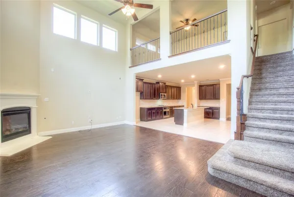 a view of a kitchen with furniture and wooden floor