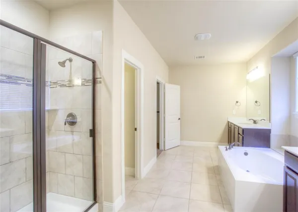 a bathroom with a bathtub shower and sink
