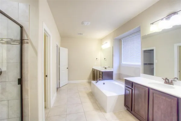 a bathroom with a bathtub shower sink and toilet