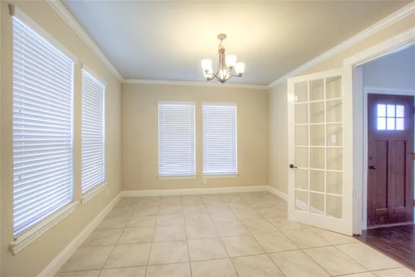 an empty room with windows and entrance