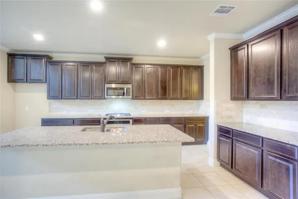 a kitchen with stainless steel appliances granite countertop wooden cabinets a sink and dishwasher