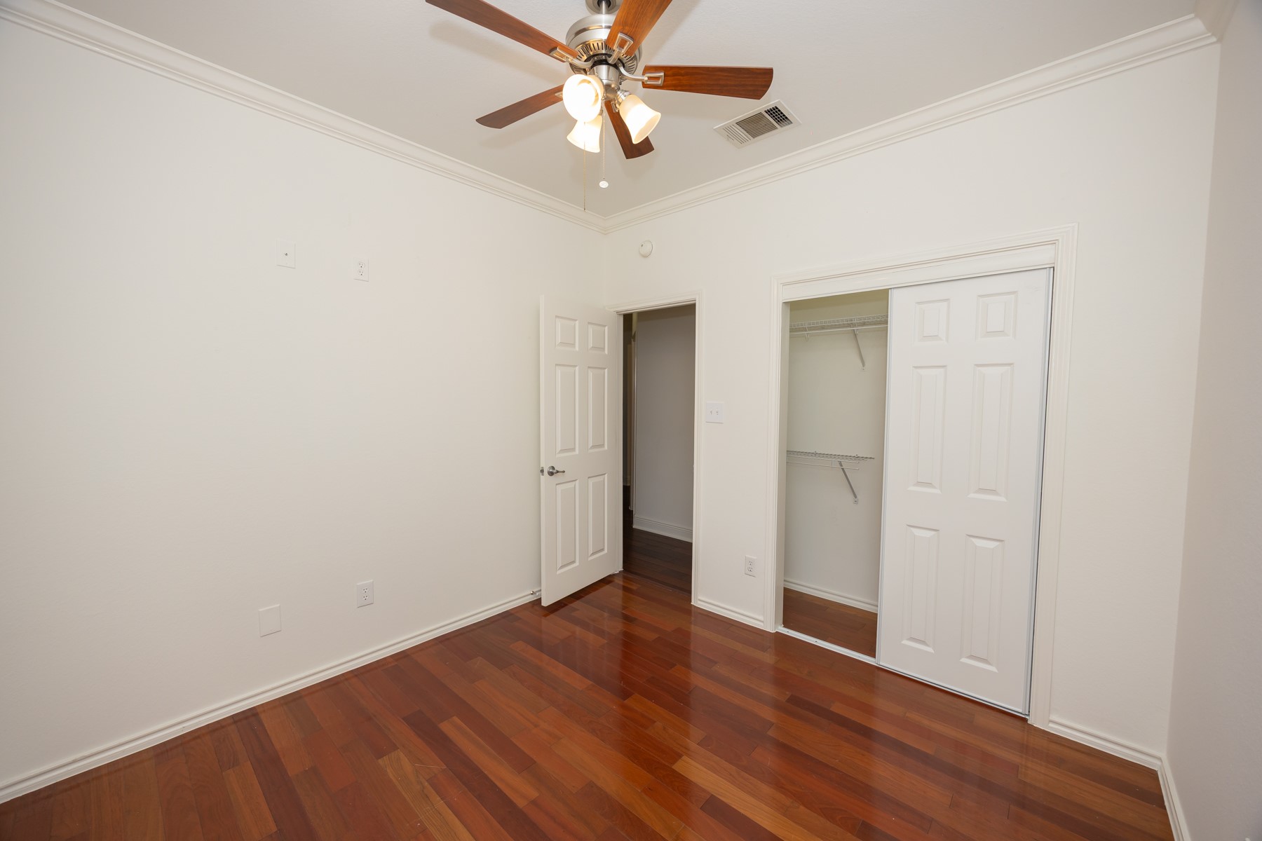 11500 Dimmit Street Manor, TX 78653 - Photo 13 of 14 Hardwood-finish flooring, crown molding, and a ceiling fan with integrated lighting