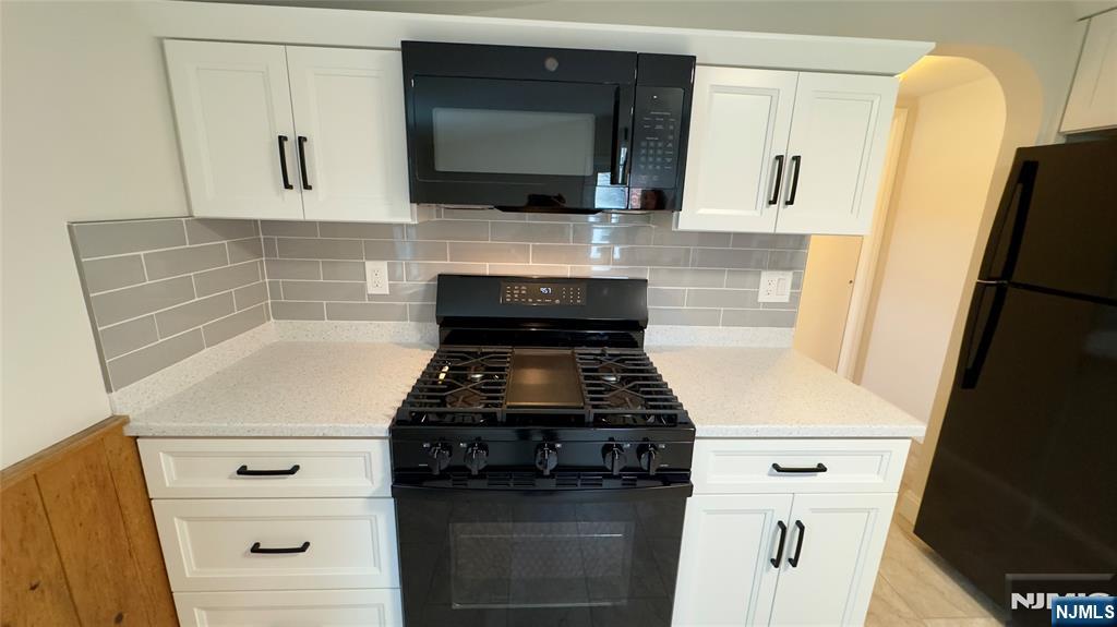 163 Center Street, Unit 2 New Milford, NJ 07646 - Photo 11 of 25 a kitchen with white cabinets and white appliances