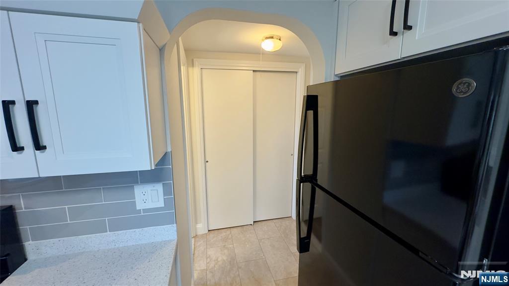 163 Center Street, Unit 2 New Milford, NJ 07646 - Photo 13 of 25 a view of a hallway with wooden floor and staircase