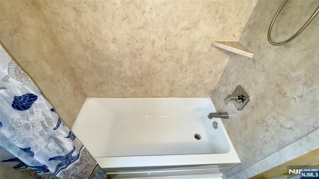 163 Center Street, Unit 2 New Milford, NJ 07646 - Photo 14 of 25 a bathroom with a tub