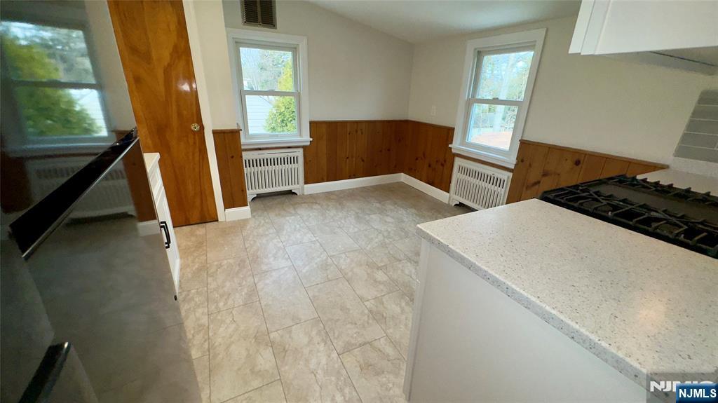 163 Center Street, Unit 2 New Milford, NJ 07646 - Photo 16 of 25 a view of a kitchen with wooden floor and electronic appliances