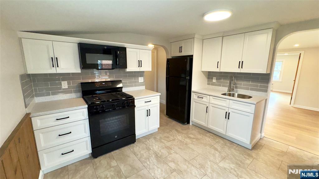 163 Center Street, Unit 2 New Milford, NJ 07646 - Photo 18 of 25 a kitchen with stainless steel appliances white cabinets and a refrigerator