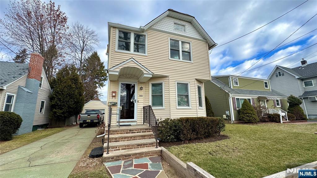 163 Center Street, Unit 2 New Milford, NJ 07646 - Photo 24 of 25 a front view of a house with a yard