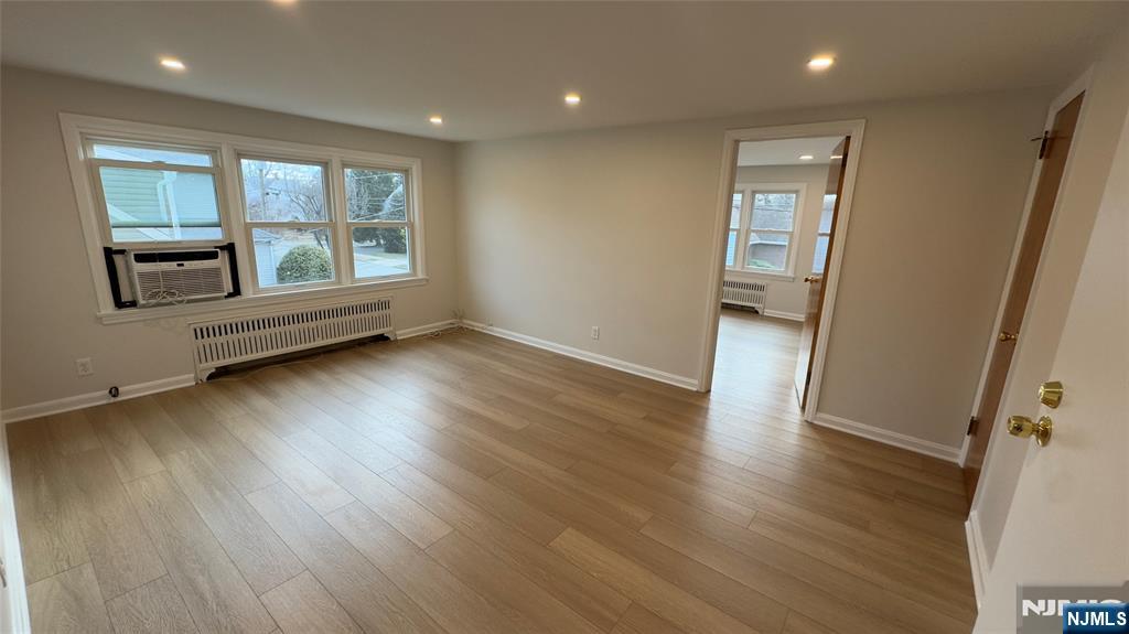 163 Center Street, Unit 2 New Milford, NJ 07646 - Photo 3 of 25 an empty room with wooden floor and windows