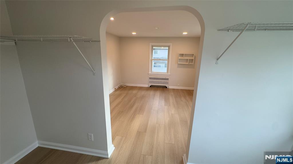 163 Center Street, Unit 2 New Milford, NJ 07646 - Photo 6 of 25 a view of hallway with a window and wooden floor