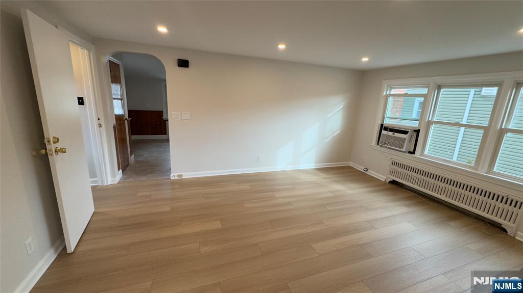 163 Center Street, Unit 2 New Milford, NJ 07646 - Photo 8 of 25 an empty room with wooden floor and windows