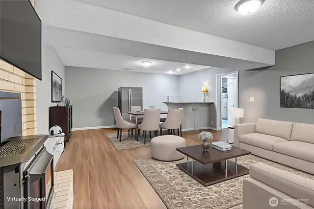 a living room with furniture a fireplace and a flat screen tv