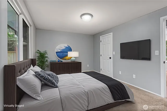 a bedroom with a bed and glass window