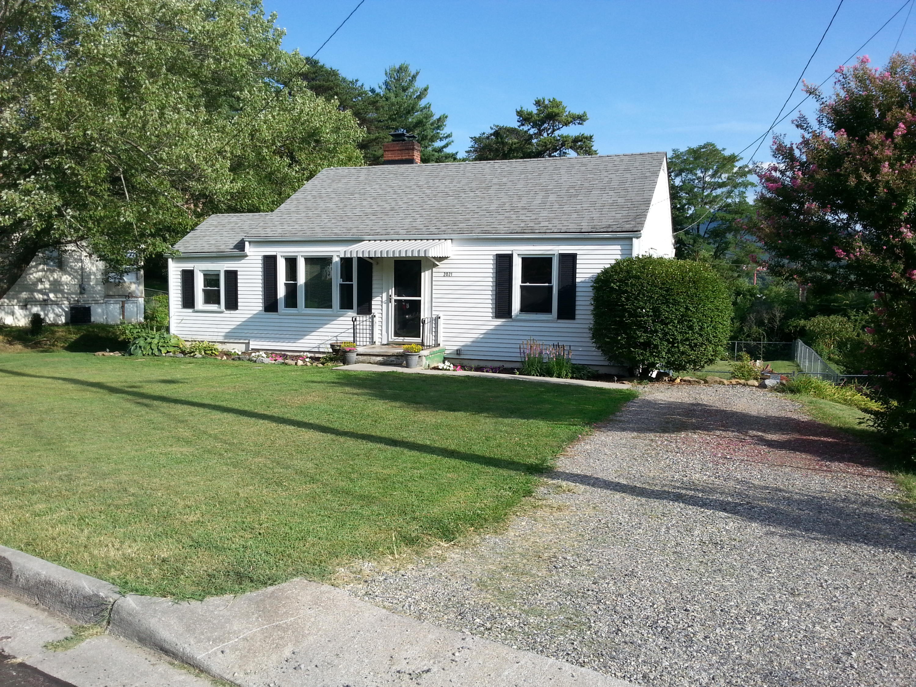 2021 Burma Road Salem, VA 24153 - Photo 1 of 13 a front view of a house with a yard and garage