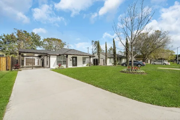 a front view of house with yard and green space