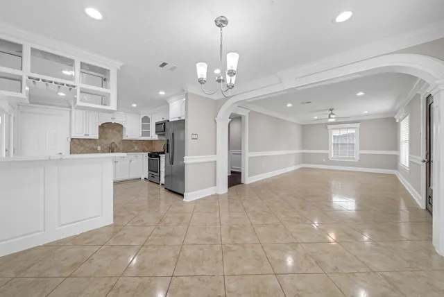 a view of a kitchen with a sink and a living room view