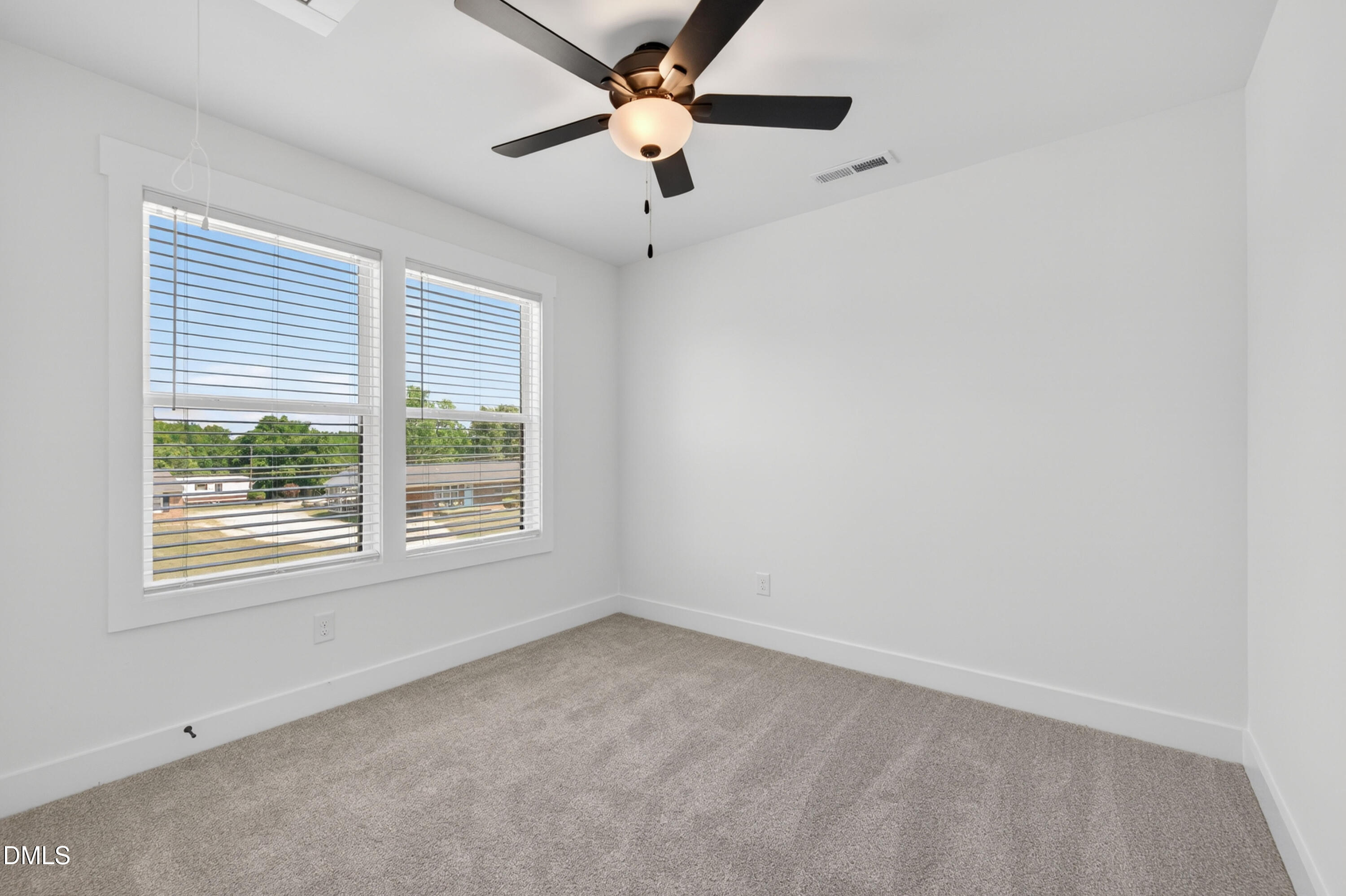 1182 Hurdle Mills Road Roxboro, NC 27573 - Photo 33 of 45 an empty room with a window and a fan