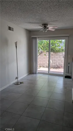 a view of a livingroom with a floor to ceiling window and an outdoor space