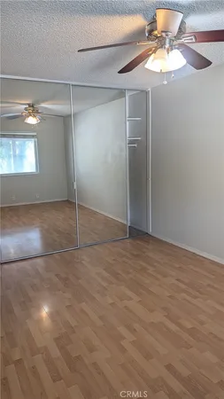 a view of an empty room with a fan