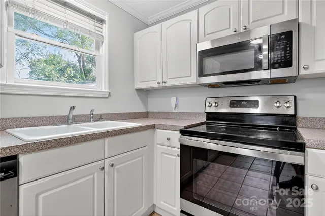 a kitchen with stainless steel appliances granite countertop a stove microwave and cabinets