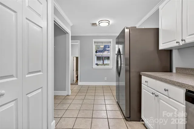 a kitchen with stainless steel appliances granite countertop a refrigerator and a stove