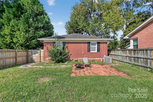 a backyard of a house with table and chairs