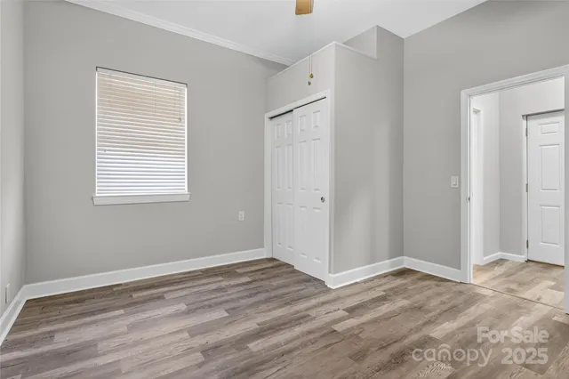 a view of a room with wooden floor and closet