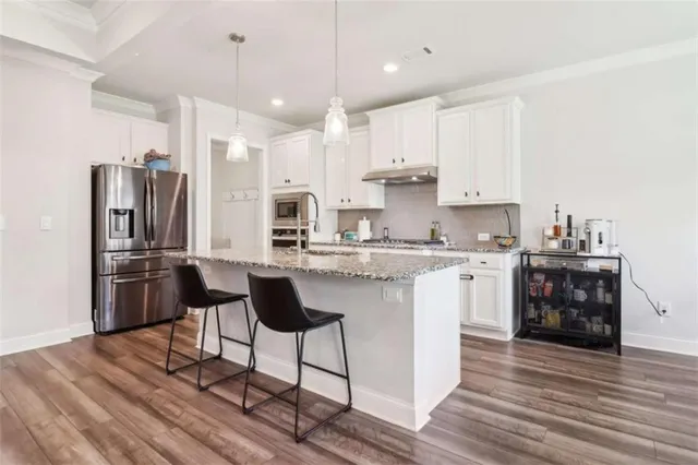 a bedroom with furniture and a wooden floor