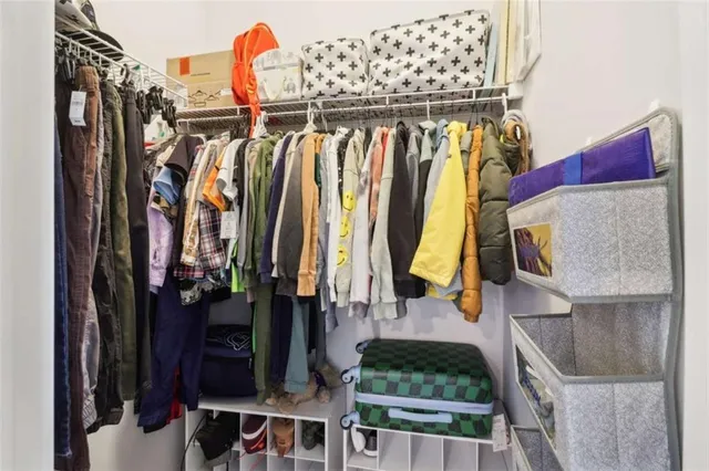 a bedroom with a bed and painting on the wall