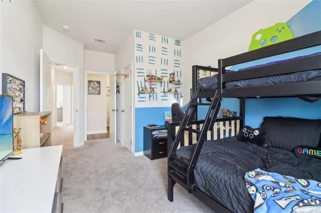 a spacious bedroom with a bed and a couch