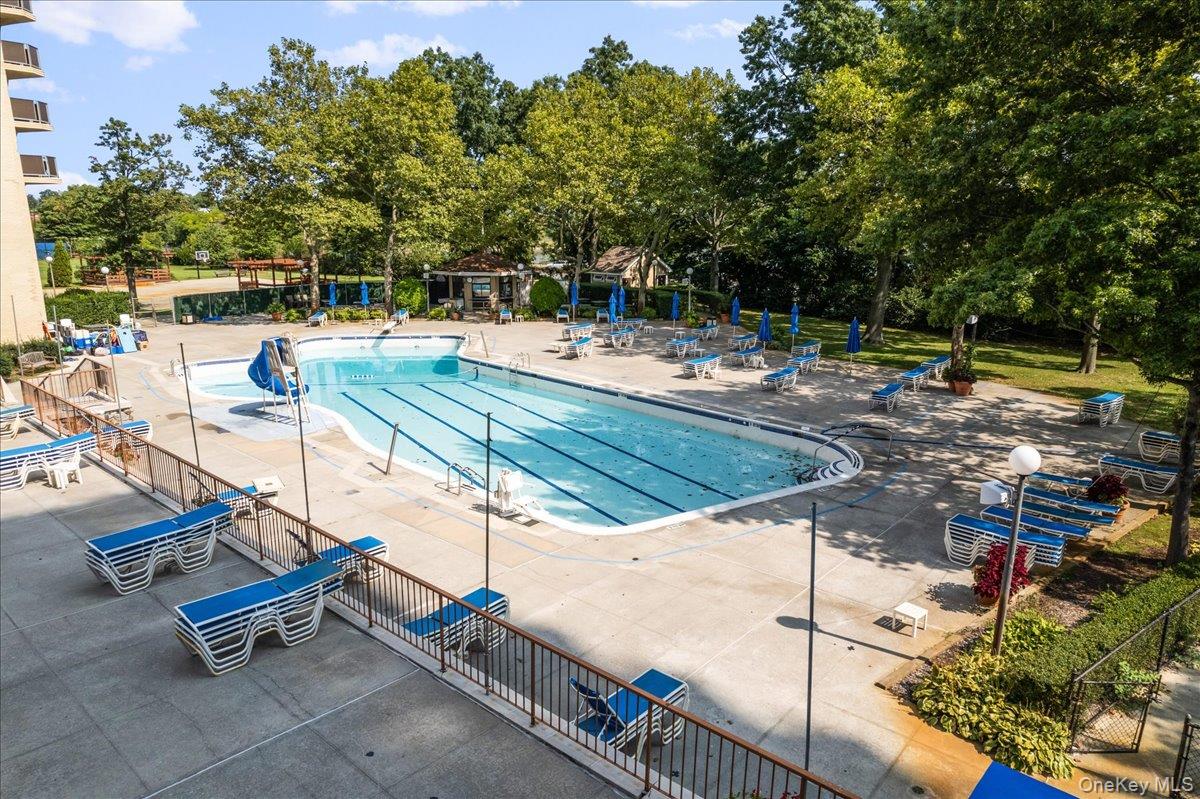 17-85 215th Street, Unit 1E Queens, NY 11360 - Photo 31 of 34 a view of swimming pool with chairs