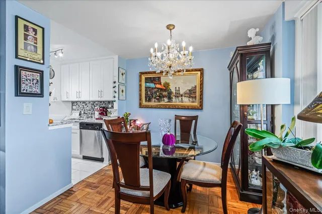 a view of a dining room with furniture and chandelier