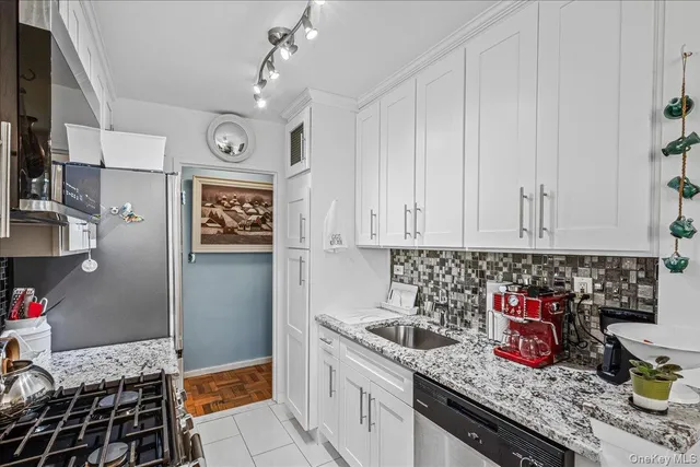 a kitchen with granite countertop a sink and cabinets