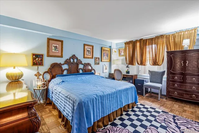 a bedroom with bed and wooden floor