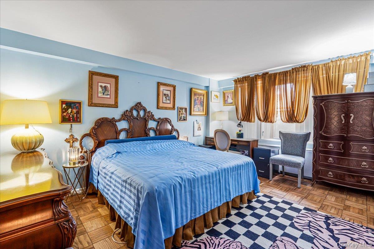 17-85 215th Street, Unit 1E Queens, NY 11360 - Photo 9 of 34 a bedroom with bed and wooden floor