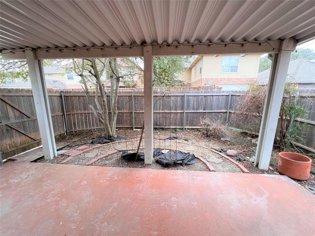 738 Ridgemont Drive Allen, TX 75002 - Photo 19 of 21 Covered patio with a corrugated metal roof and a stained concrete surface