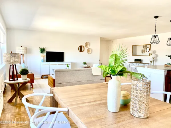 a dining room with furniture and wooden floor