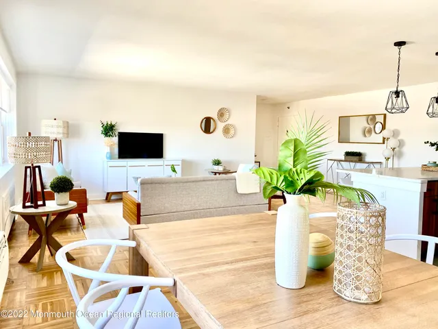 a dining room with furniture and wooden floor
