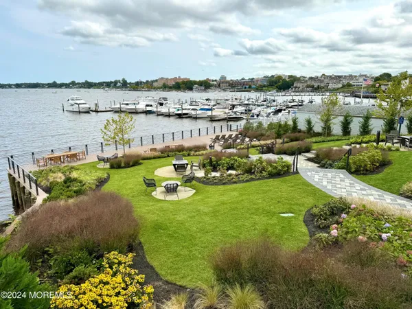 a view of a lake with couches and city view