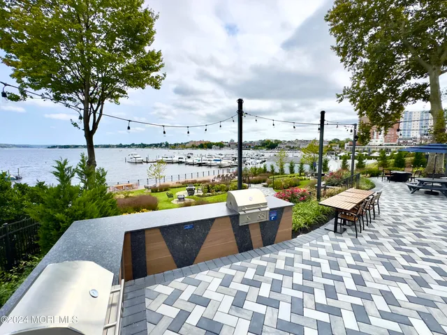 a view of swimming pool with outdoor seating and plants