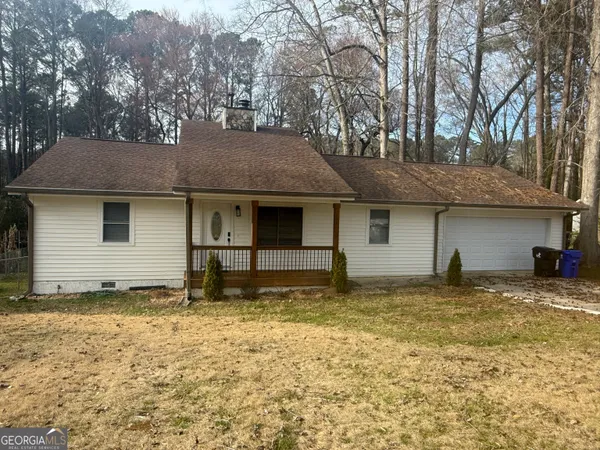 a house that has a tree in front of it