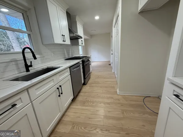 a stove top oven sitting inside of a kitchen